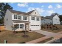 Two-story house with beige vinyl siding, gray trim, and a two-car garage at 2680 Andes Dr, Statesville, NC 28625