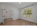 Bright home office features hardwood floors and a window with blinds at 15208 Autumn Sage Dr, Charlotte, NC 28278