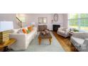 Bright living room with a fireplace, hardwood floors, and comfortable seating at 3867 Maxwell Henry Nw Ln, Conover, NC 28613