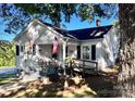 White one-story home with a ramp and American flag at 1407 N Ashe Ave, Newton, NC 28658