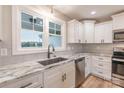 Modern kitchen with white cabinets, granite countertops, and a large sink at 118 Alf Hoover Rd, Lincolnton, NC 28092