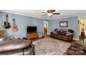 Comfortable living room featuring hardwood floors and a brown leather couch at 4677 Ramsey Rd, Sharon, SC 29742