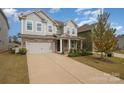 Two-story gray house with stone accents and a two-car garage at 3057 Burnello Ct, Iron Station, NC 28080