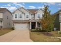 Two-story gray house with stone accents and a two-car garage at 3057 Burnello Ct, Iron Station, NC 28080