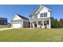 Two-story home with gray and white siding, two-car garage at 201 Wedge View Way, Statesville, NC 28677