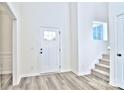 Bright entryway with white door and gray flooring at 201 Wedge View Way, Statesville, NC 28677