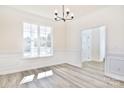 Formal dining room with wainscoting and hardwood floors at 201 Wedge View Way, Statesville, NC 28677