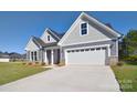 Gray house with white garage door and landscaping at 103 Bunker Hill Ln, Statesville, NC 28677