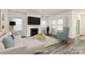 Virtually staged living room with fireplace and hardwood floors at 7403 American Elm Rd, Charlotte, NC 28215