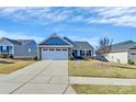 Ranch style home with gray siding, stone accents, and a two-car garage at 4321 Stream Dale Nw Cir # 218, Concord, NC 28027