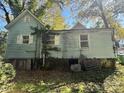 Older home with weathered siding, overgrown landscaping, and needs some TLC at 1115 Harrill St, Charlotte, NC 28205