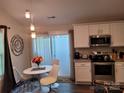 Modern kitchen with white cabinets, granite counters, and stainless steel appliances at 1025 Old Charlotte Rd, Statesville, NC 28677