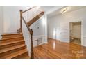 Wooden staircase with white railing and hardwood floors at 127 E Branch Ave, Shelby, NC 28152