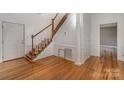 Hardwood floors, white walls, and staircase at 127 E Branch Ave, Shelby, NC 28152