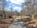 Stone pillars and metal gate entrance to a private property at 590 Tuckertown Rd, New London, NC 28127