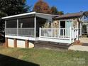 Mobile home with screened porch and deck at 104 Cardinal Ave, New London, NC 28127