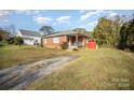 Brick ranch home with a long driveway and a spacious yard at 131 E Branch Ave, Shelby, NC 28152