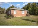 Brick ranch home with a large yard and mature trees at 131 E Branch Ave, Shelby, NC 28152