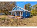Quaint blue house, featuring a front porch and yard at 480 Wyatt Grove Church Rd, Gold Hill, NC 28071
