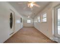 Bright sunroom with carpeted floors, multiple windows, and ceiling fans at 2926 Englewood Dr, Shelby, NC 28150
