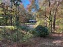 House nestled in a wooded area, seen from afar at 124 Lee Mccurry Rd, Lincolnton, NC 28092