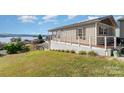 Elevated home with deck overlooking the lake at 127 Lake View Dr, New London, NC 28127