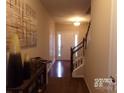 Inviting entryway with hardwood floors and staircase leading upstairs at 14121 Winford Ln, Charlotte, NC 28262