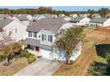 Two-story house with gray siding, two-car garage, and backyard at 620 Smokehouse Ln, Albemarle, NC 28001