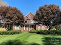 Brick house with a two-car garage, a welcoming porch, and manicured lawn at 103 Berea Baptist Church Rd, Stanfield, NC 28163