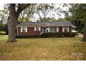 Brick ranch home with mature trees and landscaping at 2427 Rhyneland St, Gastonia, NC 28054