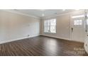 Empty living room with wood-style flooring and large window at 5540 Stafford Rd # 31, Charlotte, NC 28215