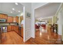 Kitchen features hardwood floors, stainless steel appliances, and granite countertops at 26508 Sandpiper Ct, Fort Mill, SC 29707