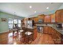 Kitchen boasts an island with seating, hardwood floors, and ample cabinetry at 26508 Sandpiper Ct, Fort Mill, SC 29707