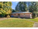 Brick ranch house with accessible ramp and yard at 1102 W Elm St, Shelby, NC 28152