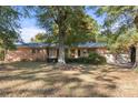 Brick ranch house with a two-car garage and large tree at 1102 W Elm St, Shelby, NC 28152