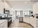 Spacious kitchen with white cabinets, an island, and stainless steel appliances at 4468 Potters Wheel Dr, Fort Mill, SC 29715