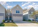 Two-story townhome with gray siding and a two-car garage at 14034 Clayborn St # 28, Midland, NC 28107