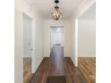 Light-filled hallway with dark wood floors and elegant chandelier at 201 Mccubbins St, Salisbury, NC 28144