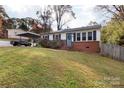 Brick ranch home with carport, landscaping, and fenced yard at 503 Cherry St, Belmont, NC 28012