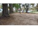 Empty lot with trees and some leaf debris at 7614 Secrest Short Cut Rd, Indian Trail, NC 28079