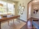 Entryway with wood floors, and a view into an office and living room at 4540 Potters Wheel Dr, Fort Mill, SC 29715