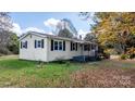 Side view of yellow ranch home with black shutters at 3925 Phelps Rd, Vale, NC 28168