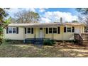 Yellow ranch home with black shutters and front porch at 3925 Phelps Rd, Vale, NC 28168