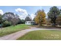 Ranch home with yard, driveway, and mature trees at 3925 Phelps Rd, Vale, NC 28168
