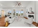 Bright living room with white slipcovered furniture, fireplace, and access to outdoor patio at 108 Augusta Ln, Shelby, NC 28150