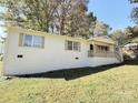 White brick ranch house with a light brown porch and well-maintained lawn at 407 Larkhall Ct, Gastonia, NC 28052