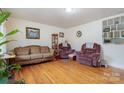 Living room with hardwood floors, couches, and built-in shelving at 955 Clanton Rd, Charlotte, NC 28217