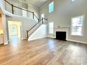 Spacious living room with hardwood floors, a fireplace, and two-story high ceilings at 9805 Ardley Park Way # 29, Mint Hill, NC 28227