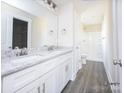 Modern bathroom with double vanity, granite countertop, and a shower/tub combo at 1327 Old Salisbury Rd, Statesville, NC 28625