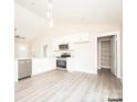 Modern kitchen featuring white cabinets, granite countertops, and stainless steel appliances at 1327 Old Salisbury Rd, Statesville, NC 28625